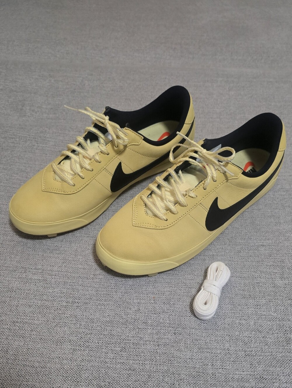 Nike Astro Grabber soft yellow and black sneakers